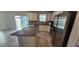 Modern kitchen featuring stainless steel appliances, granite countertops, and a center island at 1556 Aspen Ave, Davenport, FL 33837