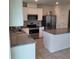 Well-designed kitchen with granite counters, stainless appliances and a convenient island layout at 1556 Aspen Ave, Davenport, FL 33837