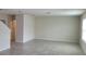 Spacious open-concept living area with tile floors, neutral walls, and plenty of natural light at 1556 Aspen Ave, Davenport, FL 33837