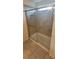 Bathroom shower features glass doors and tile surround at 1556 Aspen Ave, Davenport, FL 33837