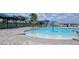Community splash pad and pool area, complete with lounge chairs and shaded seating at 1556 Aspen Ave, Davenport, FL 33837
