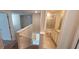Stairwell showcasing a railing, leading to a bathroom featuring a tiled shower/tub combo at 1556 Aspen Ave, Davenport, FL 33837