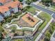 Aerial view of neighborhood playground and miniature golf course surrounded by lush landscaping, perfect for Gathering fun at 16614 Lazy Breeze Loop, Clermont, FL 34714