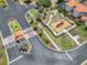 Aerial view of gated community entrance, playground, and lush landscaping, creating an inviting and secure environment at 16614 Lazy Breeze Loop, Clermont, FL 34714