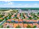 Aerial view of community with mature trees and landscaping at 16614 Lazy Breeze Loop, Clermont, FL 34714