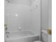 Bathroom featuring a tub and shower combination with white tile and fixtures at 16614 Lazy Breeze Loop, Clermont, FL 34714