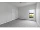 Bright bedroom features neutral carpet, a ceiling fan, and double closets for ample storage at 16614 Lazy Breeze Loop, Clermont, FL 34714