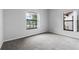 Bedroom with neutral walls, carpeted floors, and a large window offering natural light at 16614 Lazy Breeze Loop, Clermont, FL 34714