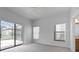 Spacious bedroom featuring neutral carpet and a sliding glass door for natural light and access at 16614 Lazy Breeze Loop, Clermont, FL 34714