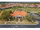 Exterior of the clubhouse in a community, featuring well-manicured landscaping and ample parking at 16614 Lazy Breeze Loop, Clermont, FL 34714