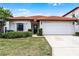 Charming single-story home showcasing a red tile roof, well-maintained lawn, and an attached two-car garage at 16614 Lazy Breeze Loop, Clermont, FL 34714