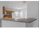 Kitchen featuring tiled floors, neutral countertops, wooden cabinets, and an adjacent breakfast nook at 16614 Lazy Breeze Loop, Clermont, FL 34714