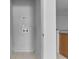 Utility room featuring washer and dryer hookups in a neutral, tiled space at 16614 Lazy Breeze Loop, Clermont, FL 34714