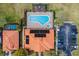 Overhead shot of a community pool and hot tub, surrounded by lounge chairs and a nearby parking area at 16614 Lazy Breeze Loop, Clermont, FL 34714