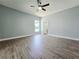 A bedroom with wood-look flooring and natural light from a window at 2312 Twickingham Ct, Clermont, FL 34711