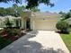 Charming home featuring a brick driveway, attached garage, and manicured landscaping at 2312 Twickingham Ct, Clermont, FL 34711