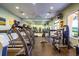 Well-equipped fitness center featuring treadmills, weights, and a mirrored wall for a complete workout experience at 2312 Twickingham Ct, Clermont, FL 34711