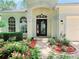 Inviting front entrance with a beautiful door and lush landscaping at 2312 Twickingham Ct, Clermont, FL 34711
