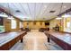 Spacious game room equipped with pool tables, seating areas, and modern lighting fixtures perfect for entertainment and relaxation at 2312 Twickingham Ct, Clermont, FL 34711