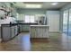 Spacious kitchen featuring modern appliances, an island and wood grain flooring at 2312 Twickingham Ct, Clermont, FL 34711