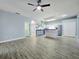 Open floor plan with hardwood floors and an adjacent modern kitchen at 2312 Twickingham Ct, Clermont, FL 34711