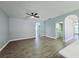 Open living room area featuring a ceiling fan and wood-look flooring at 2312 Twickingham Ct, Clermont, FL 34711