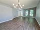 Sun-filled living space with stylish hardwood floors and a modern light fixture at 2312 Twickingham Ct, Clermont, FL 34711