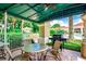 Outdoor dining area with a grill and comfortable seating perfect for entertaining and enjoying the beautiful landscape at 2312 Twickingham Ct, Clermont, FL 34711