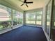 Enclosed lanai with screens and sliding doors overlooking a green area at 2312 Twickingham Ct, Clermont, FL 34711