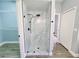 Modern walk-in shower features marble-look walls, glass door, and sleek fixtures at 2312 Twickingham Ct, Clermont, FL 34711