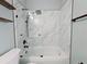 Updated walk-in shower featuring marble-look tile and modern fixtures at 2312 Twickingham Ct, Clermont, FL 34711