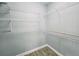Walk-in closet features multiple white wire shelving racks and wood-look flooring at 2312 Twickingham Ct, Clermont, FL 34711