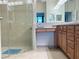 Bathroom featuring a glass-enclosed shower and vanity area, perfect for a spa-like experience at 2495 Palm Tree Dr, Kissimmee, FL 34759