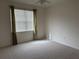 Bedroom with neutral tones, plush carpeting, and a bright window, creating a peaceful and inviting space at 2495 Palm Tree Dr, Kissimmee, FL 34759
