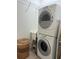 Efficient laundry room with stacked washer and dryer and ample storage solutions, perfect for organization at 2495 Palm Tree Dr, Kissimmee, FL 34759