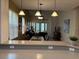 View of the open concept living and dining room with modern furniture and a calming color palette at 2495 Palm Tree Dr, Kissimmee, FL 34759