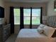 Bright main bedroom with a view of the yard, featuring neutral tones and elegant decor at 2495 Palm Tree Dr, Kissimmee, FL 34759