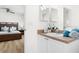 Bathroom featuring double sinks, white cabinets, and a view of a bedroom at 252 Barbera Dr, Davenport, FL 33897