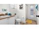 Bathroom features a window, a patterned art piece, and a walk-in shower at 252 Barbera Dr, Davenport, FL 33897