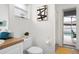 Bathroom showcases a window, a black and white art piece, and pool view access at 252 Barbera Dr, Davenport, FL 33897