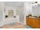 Bright bathroom with separate shower, tub, window, and wood cabinets at 252 Barbera Dr, Davenport, FL 33897