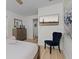 Bedroom with a TV, stylish dresser, accent chair, and an adjacent bathroom at 252 Barbera Dr, Davenport, FL 33897