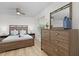 Cozy bedroom features a comfortable queen-sized bed, modern dresser, and a well-lit ambiance at 252 Barbera Dr, Davenport, FL 33897