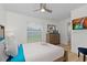 Bright bedroom features a large window overlooking the backyard and a ceiling fan at 252 Barbera Dr, Davenport, FL 33897
