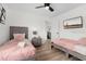 Inviting bedroom featuring two twin beds, a ceiling fan, a TV, and minimalist wall decor at 252 Barbera Dr, Davenport, FL 33897