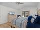 Comfortable bedroom with king bed, dresser with TV, and access to an outdoor living area at 252 Barbera Dr, Davenport, FL 33897
