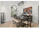 Bright dining room featuring modern light fixture, seating for six, and a large window overlooking lush greenery at 252 Barbera Dr, Davenport, FL 33897