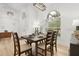 Inviting dining area with a bench, and a large window offering natural light and views of the outdoor landscape at 252 Barbera Dr, Davenport, FL 33897