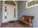 Inviting entryway featuring a white door and decorative bench, enhancing the home's curb appeal at 252 Barbera Dr, Davenport, FL 33897
