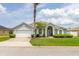 Charming single-story home featuring a two-car garage, manicured lawn, and beautiful landscaping at 252 Barbera Dr, Davenport, FL 33897